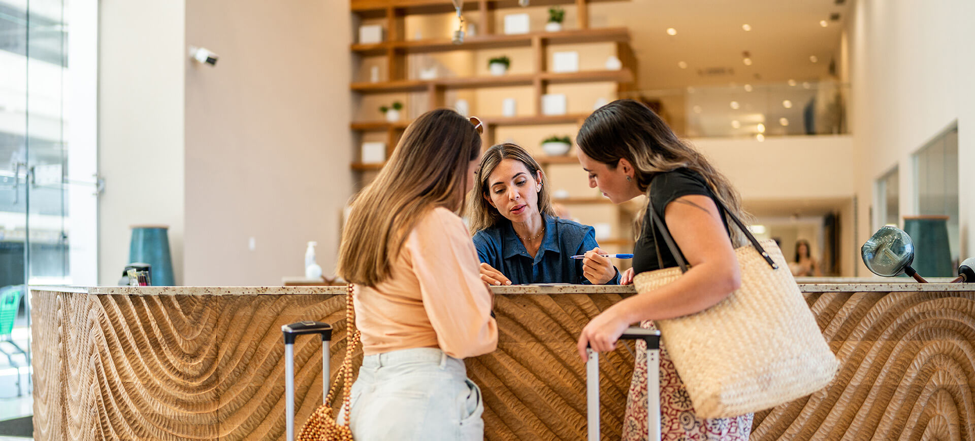 Hotel staff member helping two guests