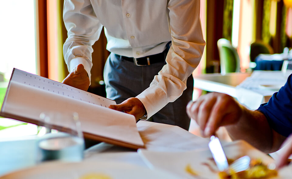 Two people looking at a restaurant menu
