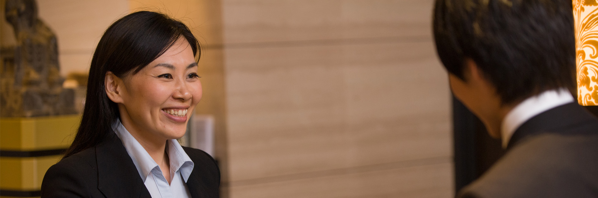 Two people at hotel lobby smiling